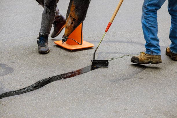 Hot pour rubberized sealant applied to a crack in asphalt