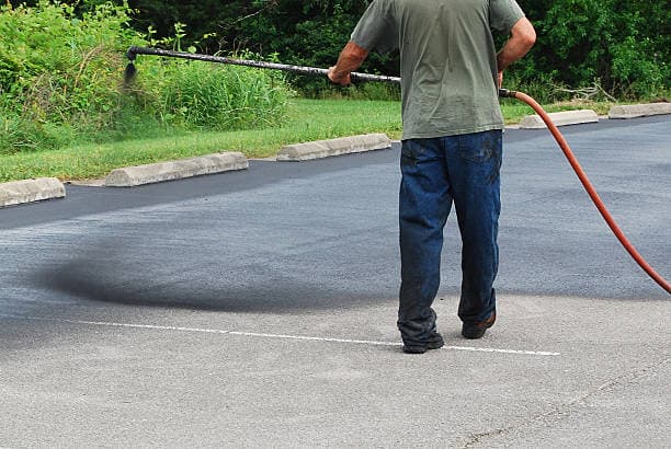 Freshly sealcoated commercial parking lot with deep black finish